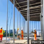 건축전기설비기사와 전기기사의 차이 - A detailed scene of a Japanese construction site focused on architectural electrical installation wo...